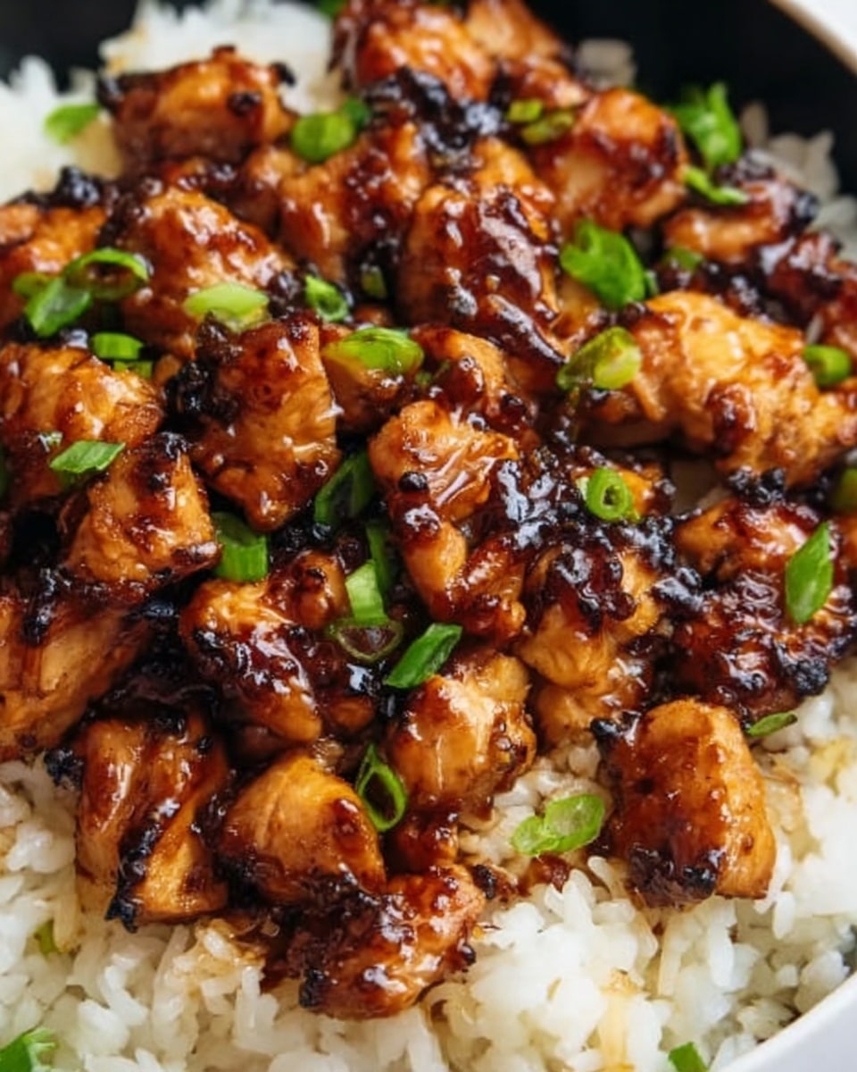 A close-up view of a large stainless steel pan filled with a hearty, textured dish made of ground meat mixed with small orange cubes, likely sweet potatoes, and bits of diced onions and tomatoes. Melted yellow and white cheese is spread unevenly on top, adding a creamy texture. Fresh green cilantro leaves are scattered across the dish, adding a bright color contrast. A wooden spoon rests inside the pan, partially covered by the food. The pan is set on a white marbled surface. photo taken with an iphone --ar 4:5 --v 7